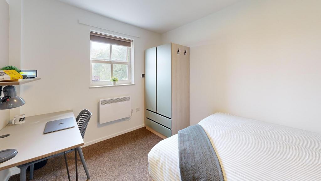 Bright, tidy bedroom with a comfortable bed, st...