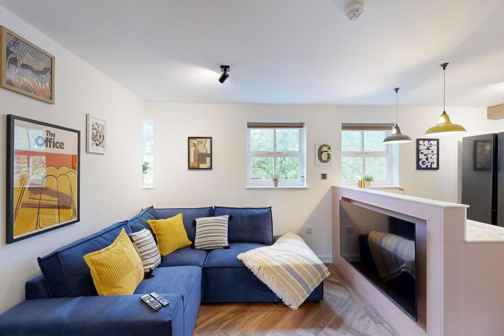 Bright, modern living room with a comfortable b...