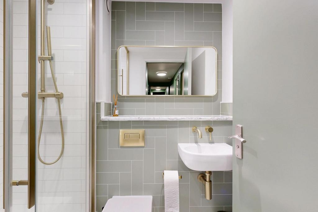 Bright, modern bathroom with a glass shower enc...