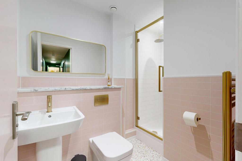 Bright, modern bathroom with pastel pink tiling...