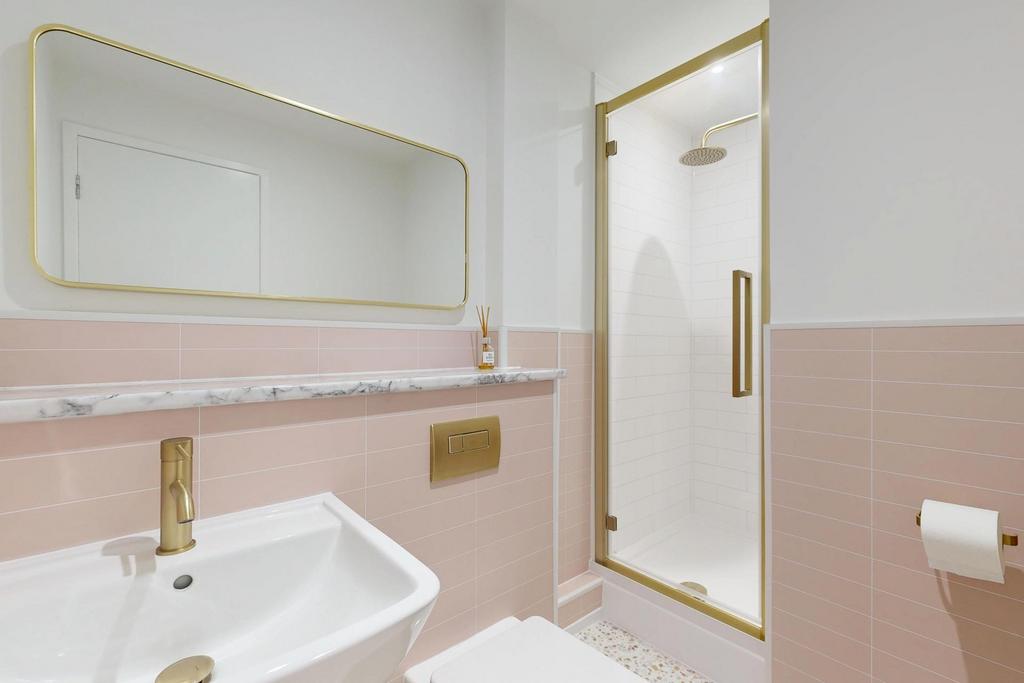 Stylish modern bathroom featuring a walk-in sho...