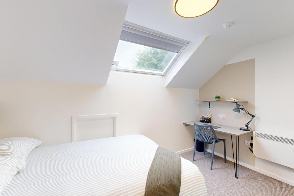 Bright, neatly presented bedroom with a comfort...