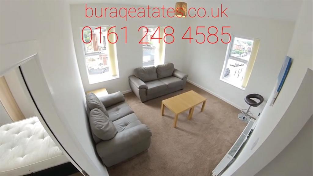 Bright, carpeted living room with two comfortab...