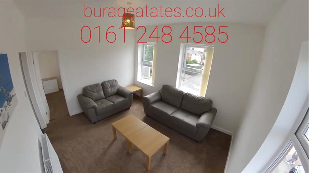 Bright, well-lit living room with two grey sofa...