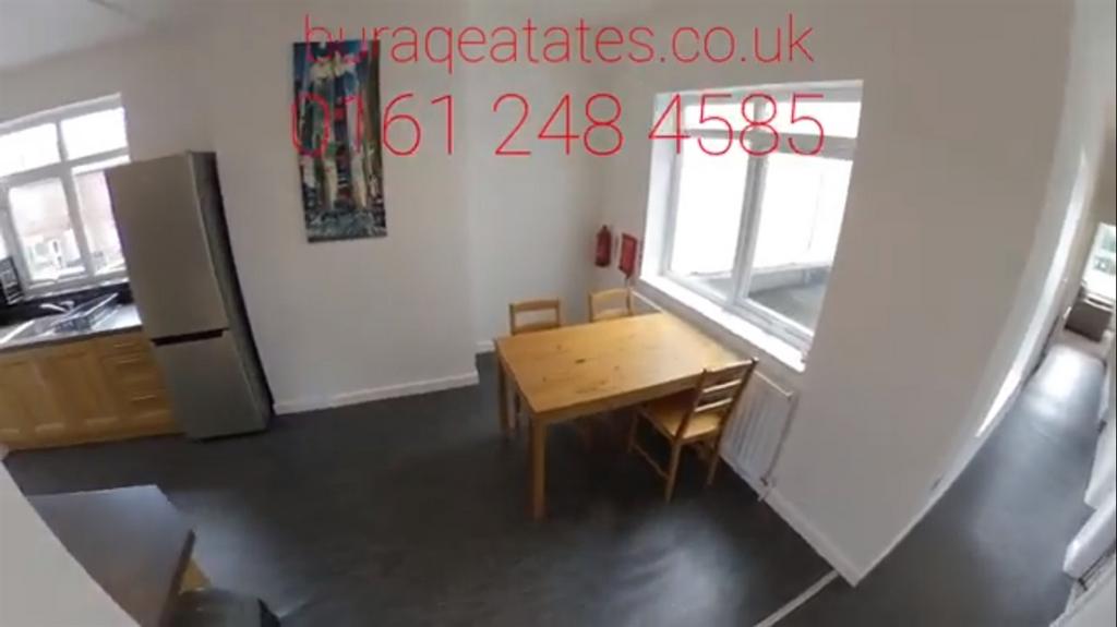 Bright kitchen area with modern appliances, a s...