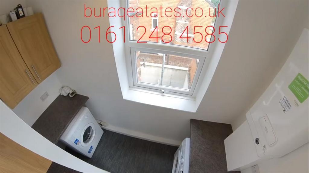 Compact kitchen with a large window providing g...