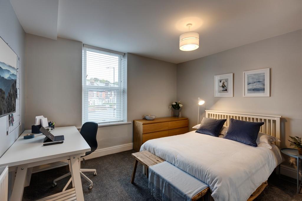 Bright, neutrally decorated double bedroom with...