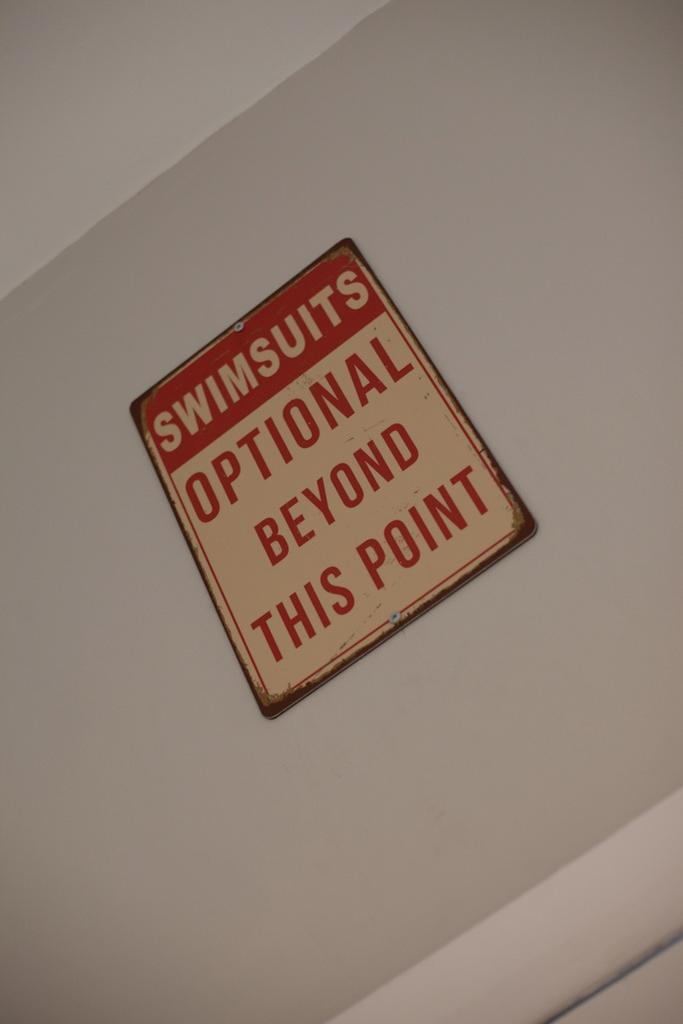 Decorative vintage sign mounted on a clean neut...