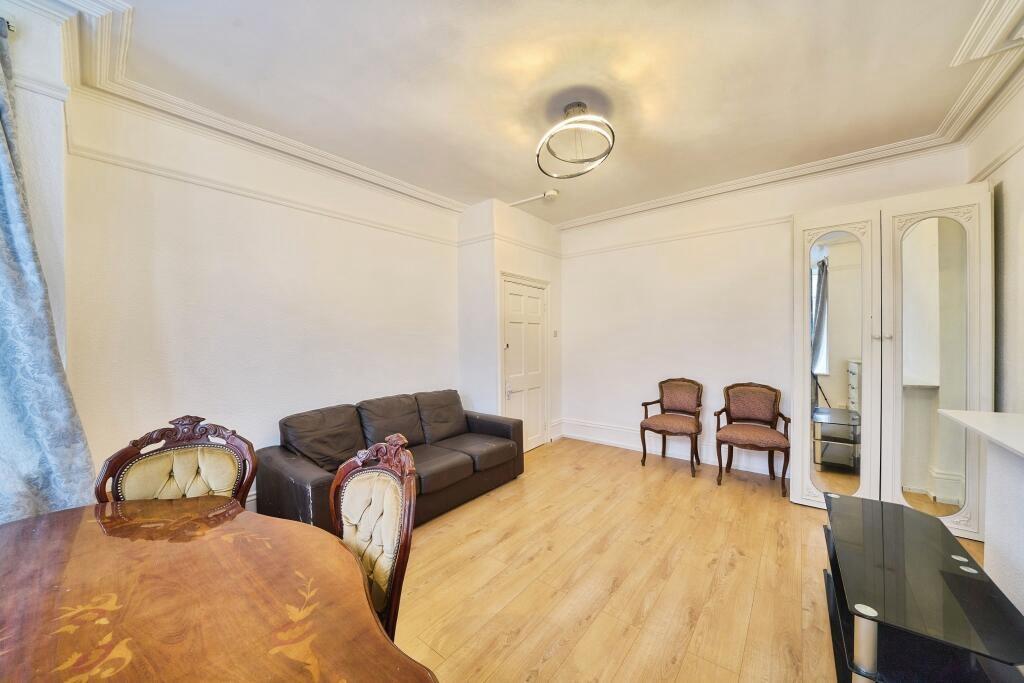 Bright furnished living room with wood-effect f...