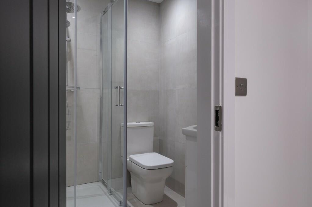 Modern, well-maintained bathroom with a walk-in...