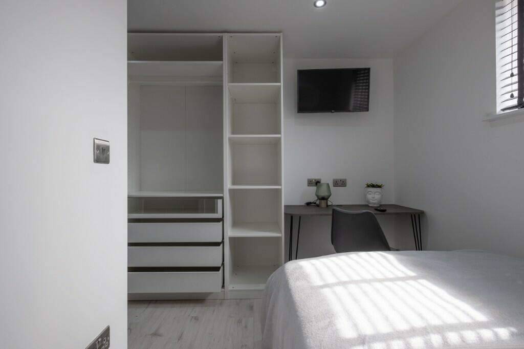 Bright, modern bedroom with built-in wardrobe, ...