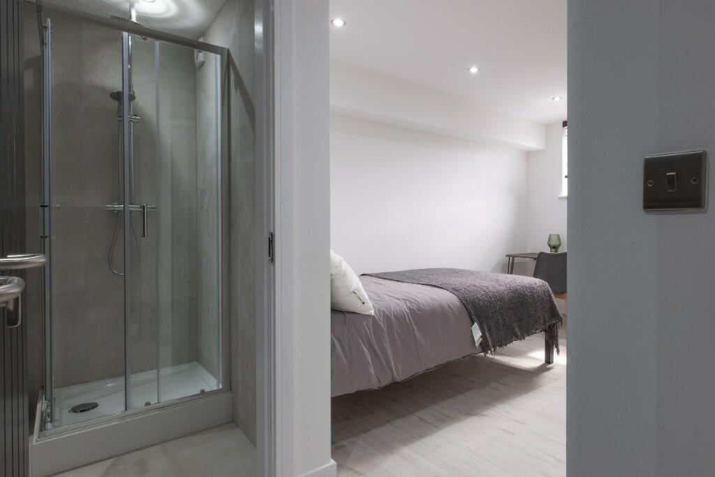 Modern double bedroom with neutral décor, a com...