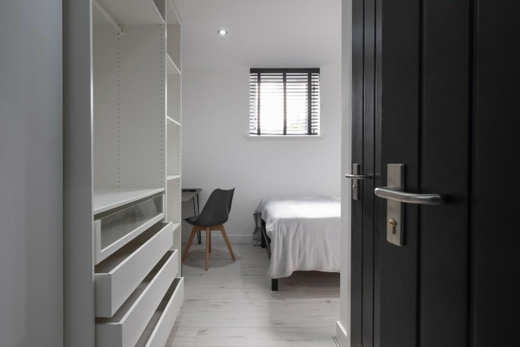 Bright, minimalist bedroom with neutral tones, ...