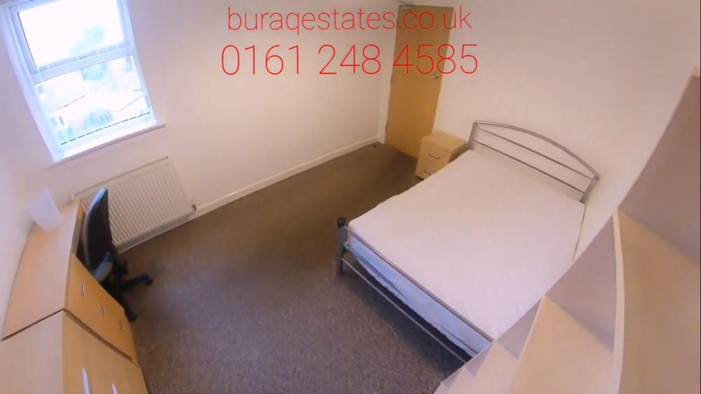 Bright, simply furnished bedroom with a double ...