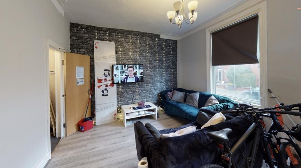 A modern, well-lit living room featuring a larg...