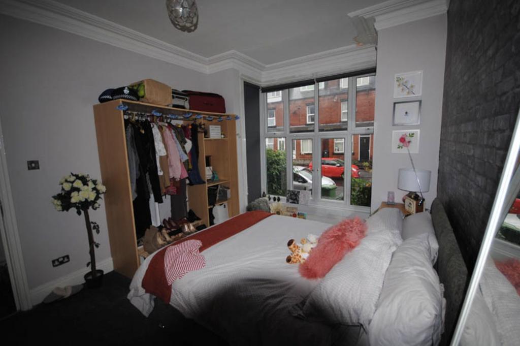 A bright and inviting bedroom featuring a comfo...