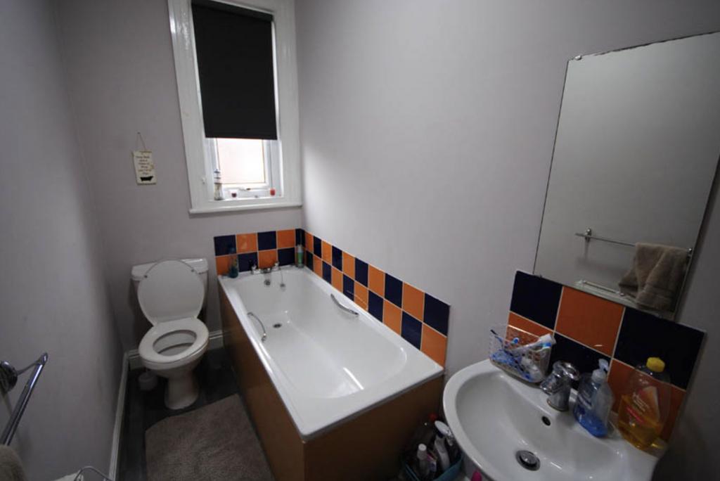 A clean and functional bathroom featuring a bat...