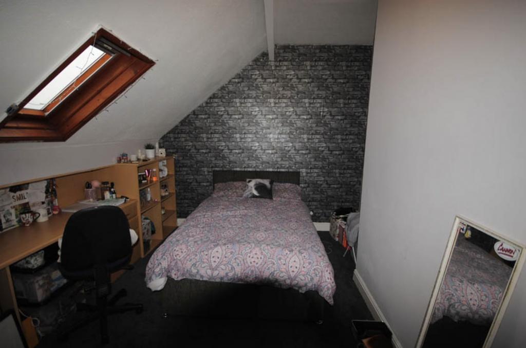 A cozy bedroom featuring a comfortable double b...
