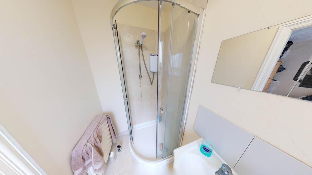 Bright and clean bathroom featuring a shower en...