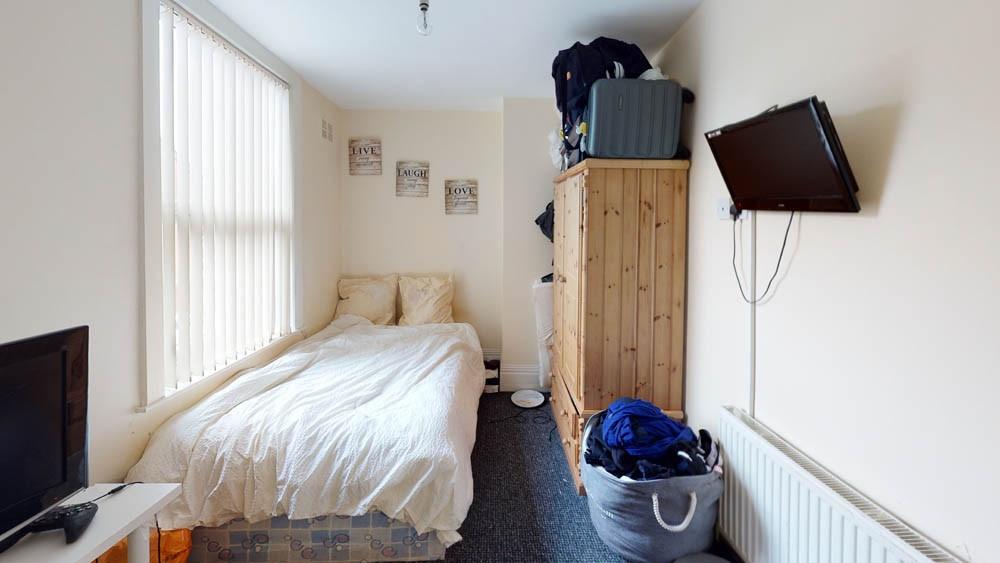 A cozy bedroom with a comfortable double bed, e...