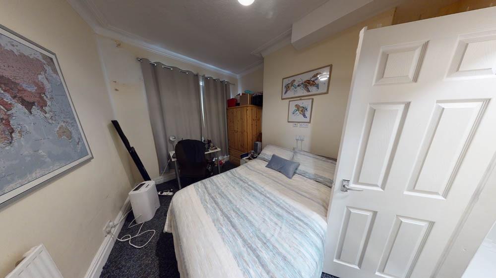 A bright and tidy bedroom featuring a double be...