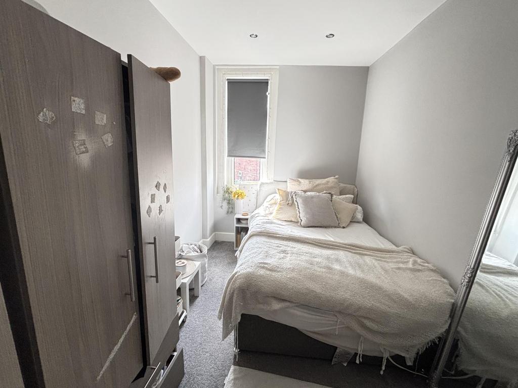 A cozy bedroom featuring a double bed and a war...