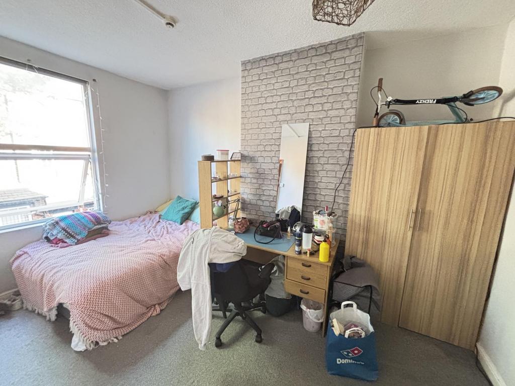 A cozy bedroom featuring a double bed and a fit...