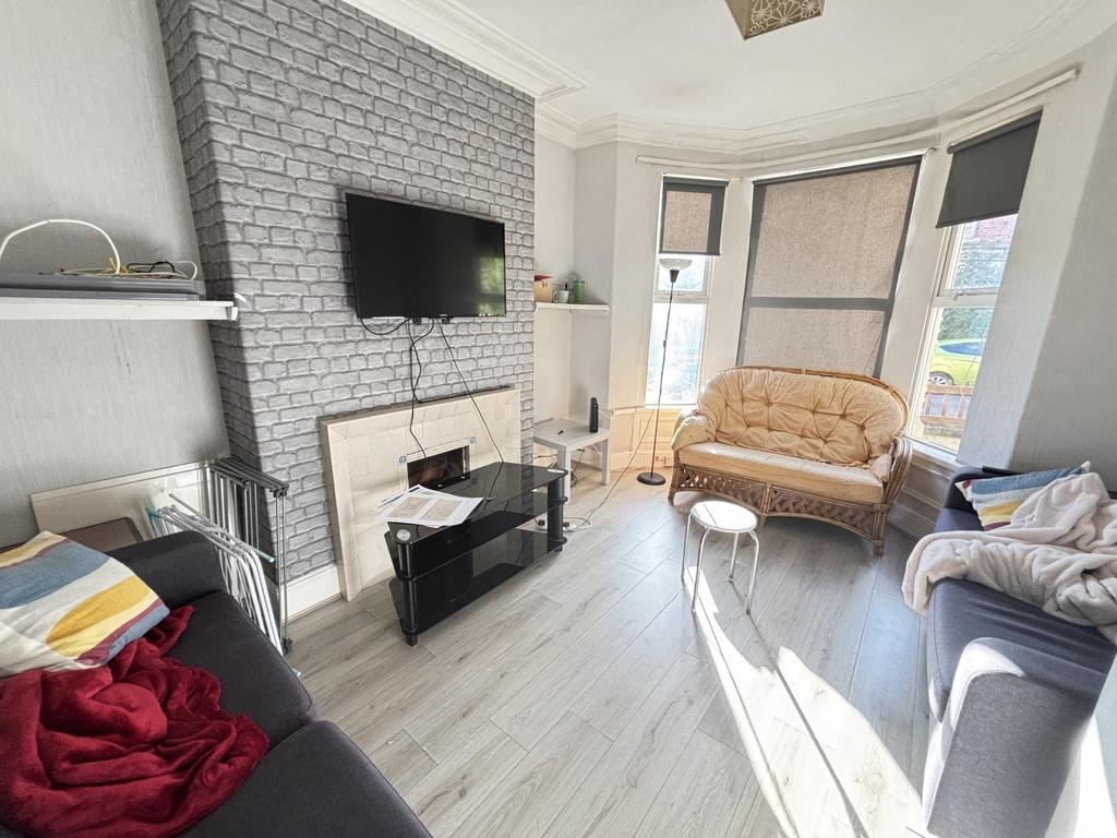 A bright and spacious living room featuring lar...