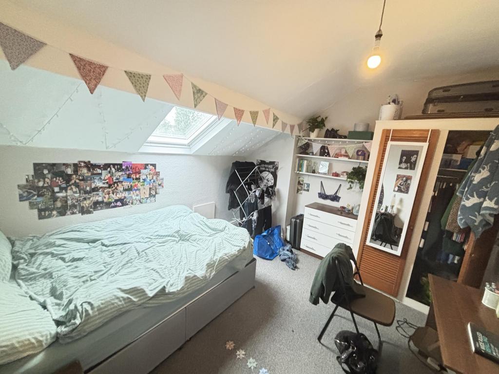A cozy bedroom featuring a double bed and a war...