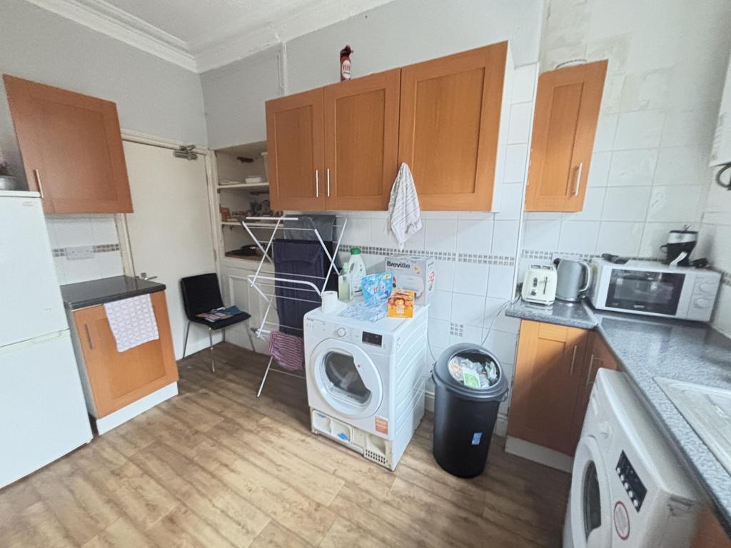 Bright and well-organized kitchen with ample co...