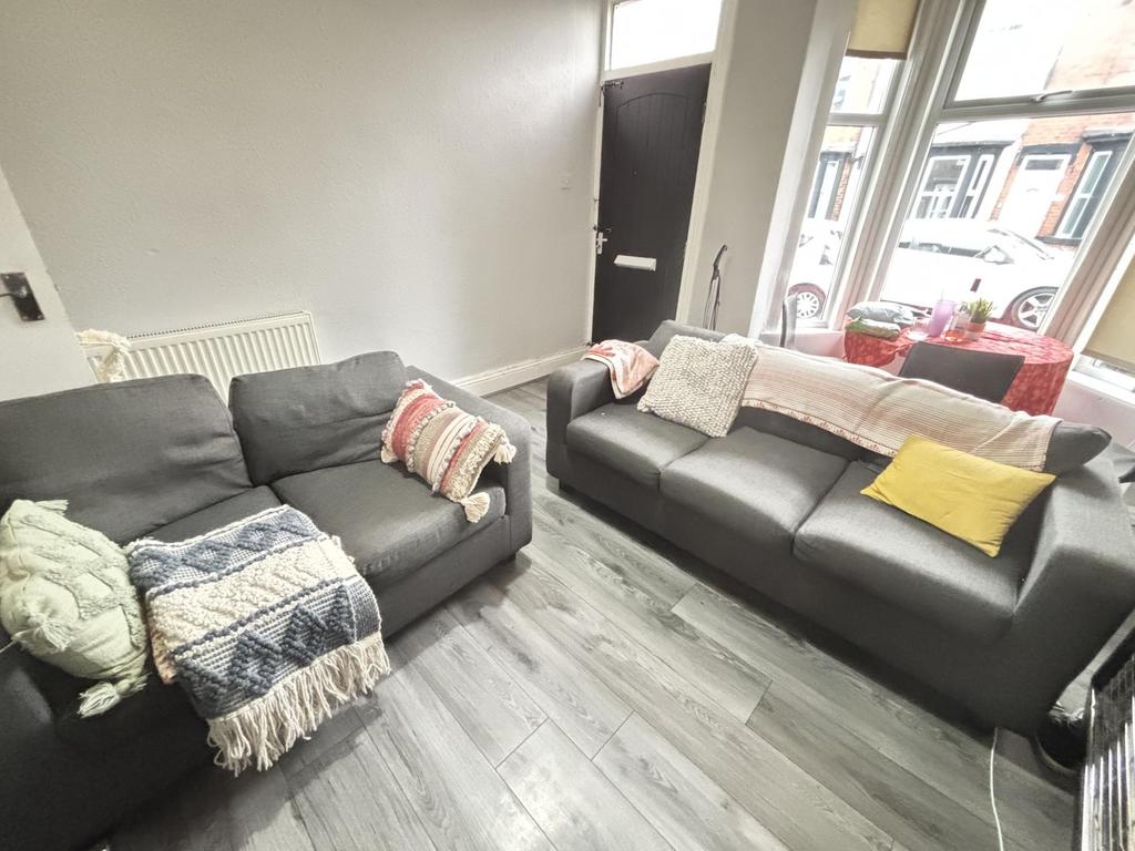 A spacious and well-lit living room with modern...