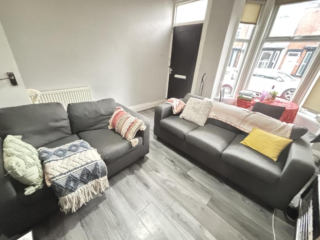 A bright, modern living room featuring two comf...
