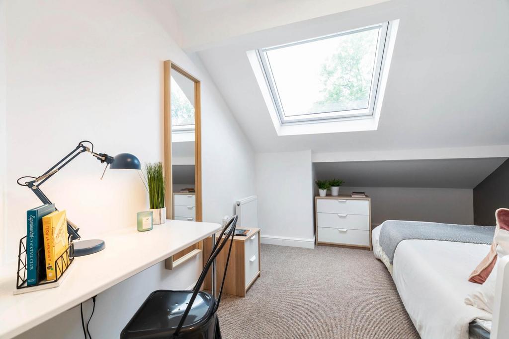 A bright and welcoming living room with ample n...