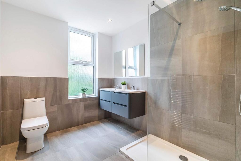 A modern, clean bathroom with a spacious shower...