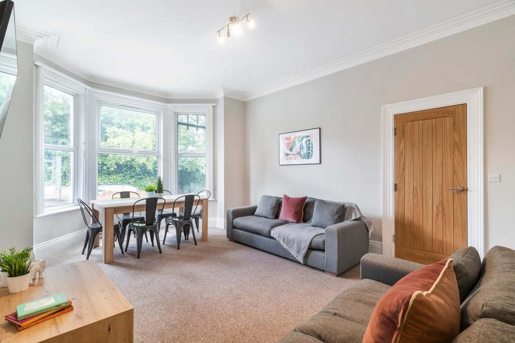 Bright and welcoming living room featuring larg...