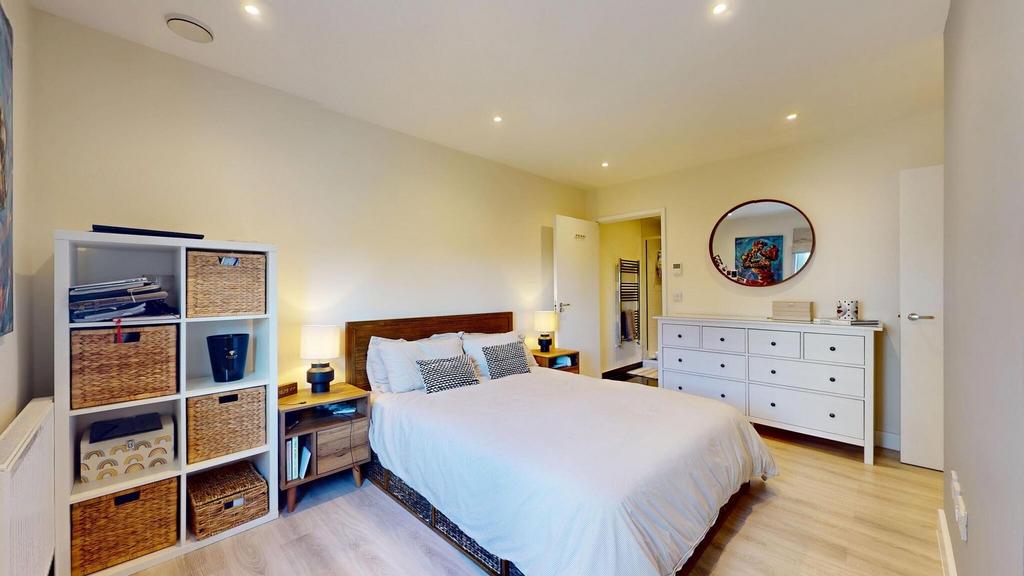 Bright and welcoming double bedroom featuring a...