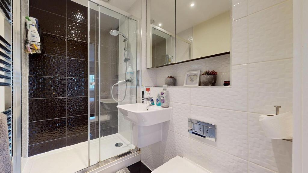 Modern bathroom featuring a sleek shower enclos...