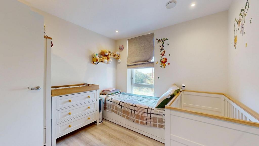 A bright and tidy single bedroom featuring a be...