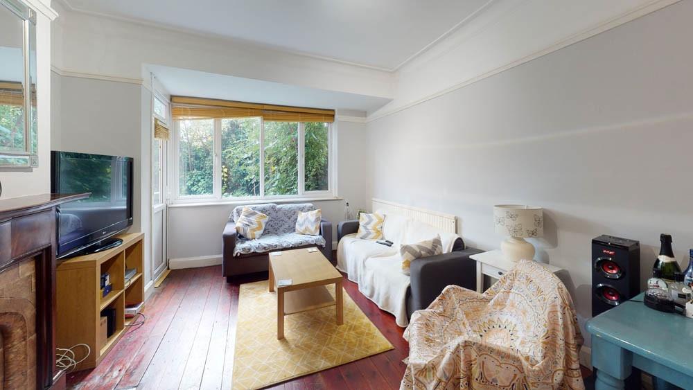 A spacious and well-lit living room featuring l...