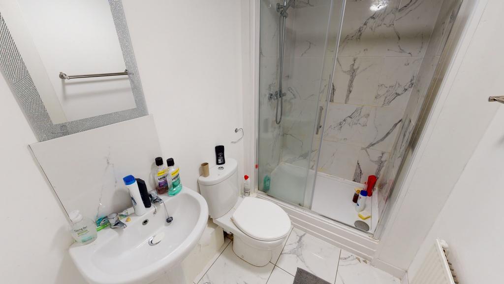 Bright and clean bathroom featuring a toilet, s...