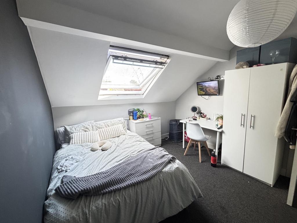 A cozy bedroom with a single bed, bright natura...