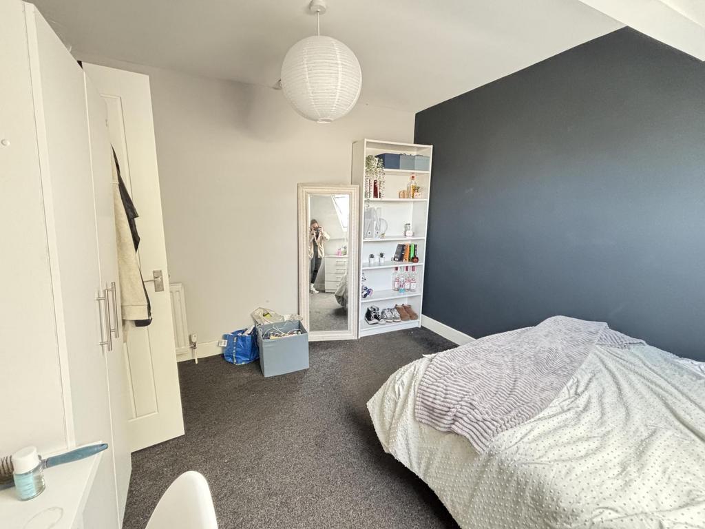 A cozy bedroom featuring a comfortable double b...