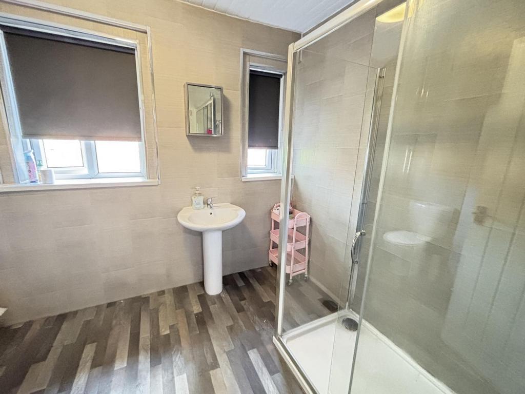 Bright and well-maintained bathroom with a show...