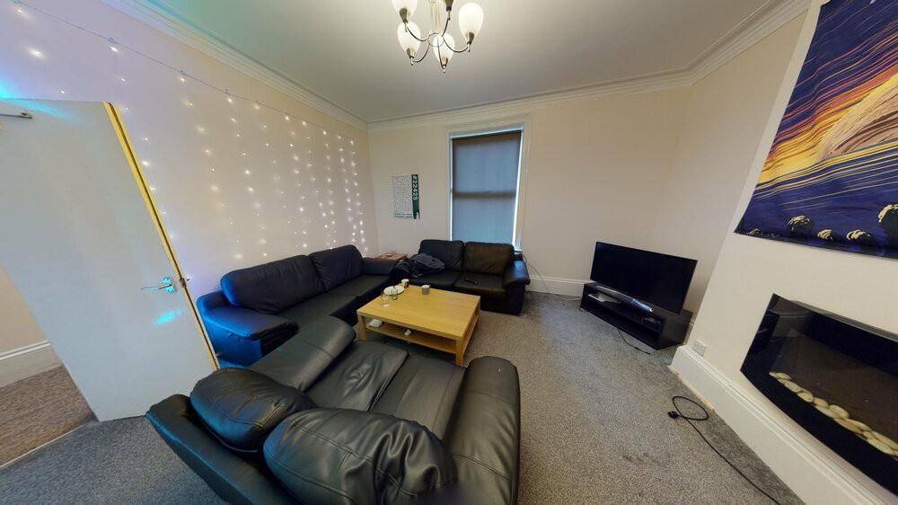A spacious, modern living room featuring comfor...