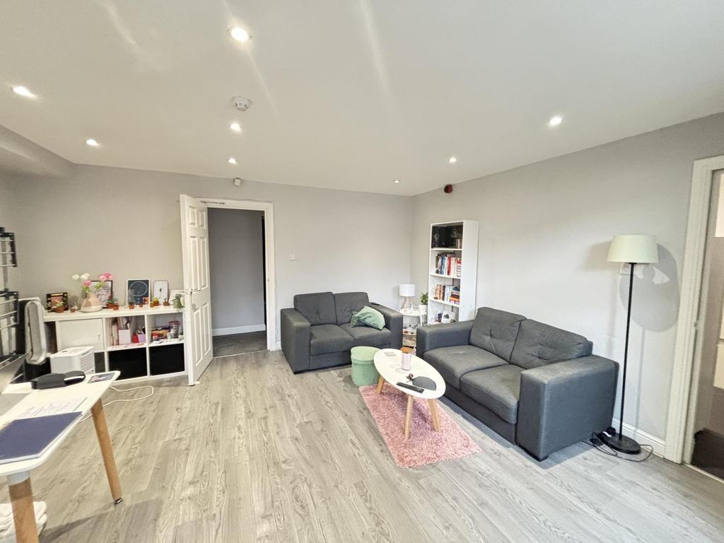 A spacious and modern living room featuring com...