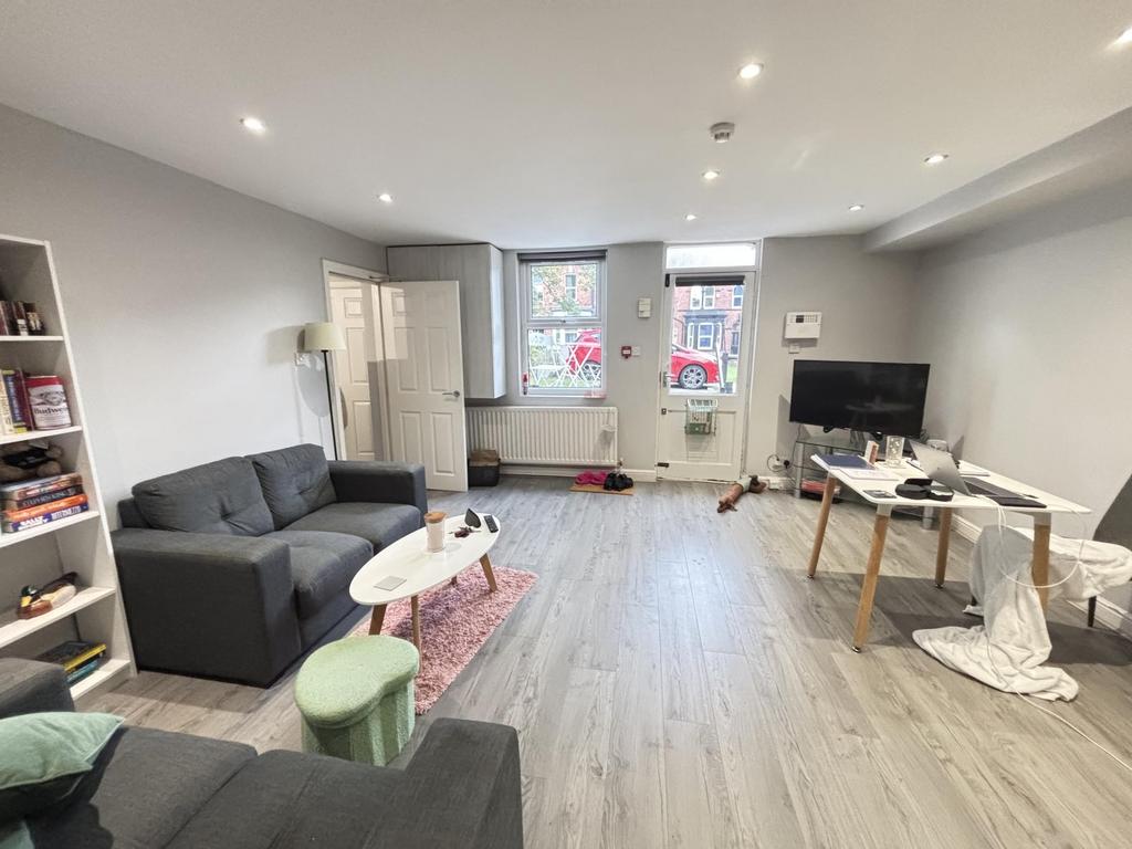 A bright and spacious living room with large wi...