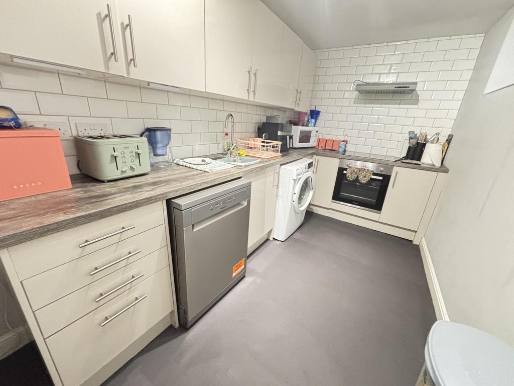 A modern kitchen with ample cabinetry, a refrig...