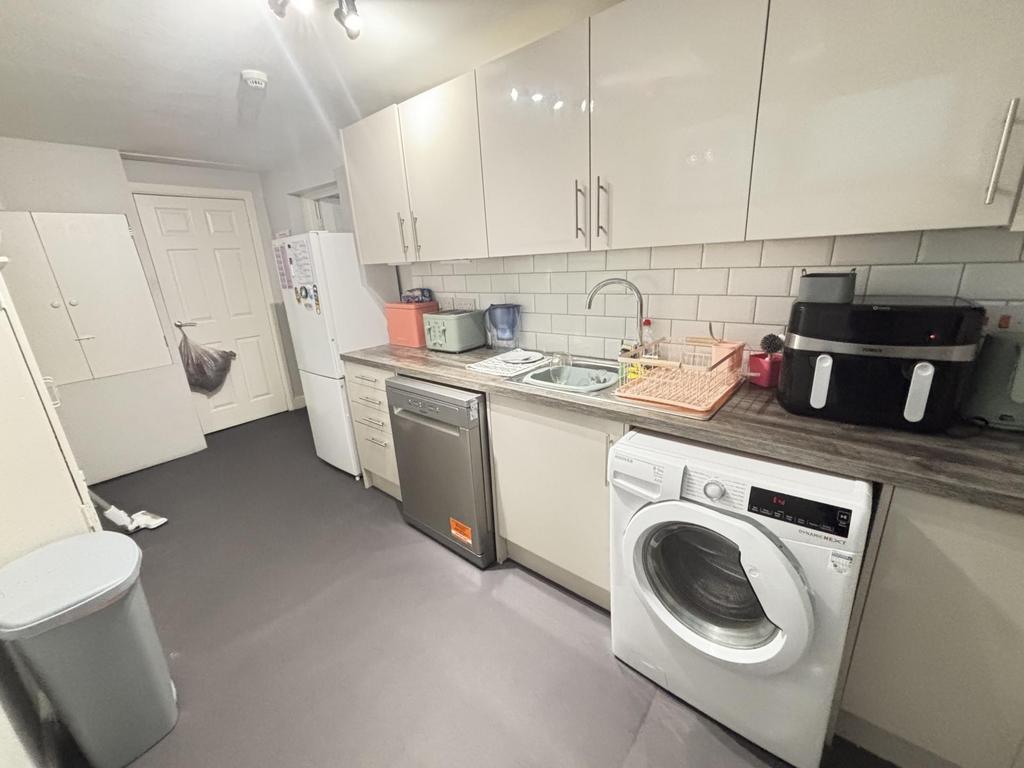 A bright, modern kitchen with white cabinets an...