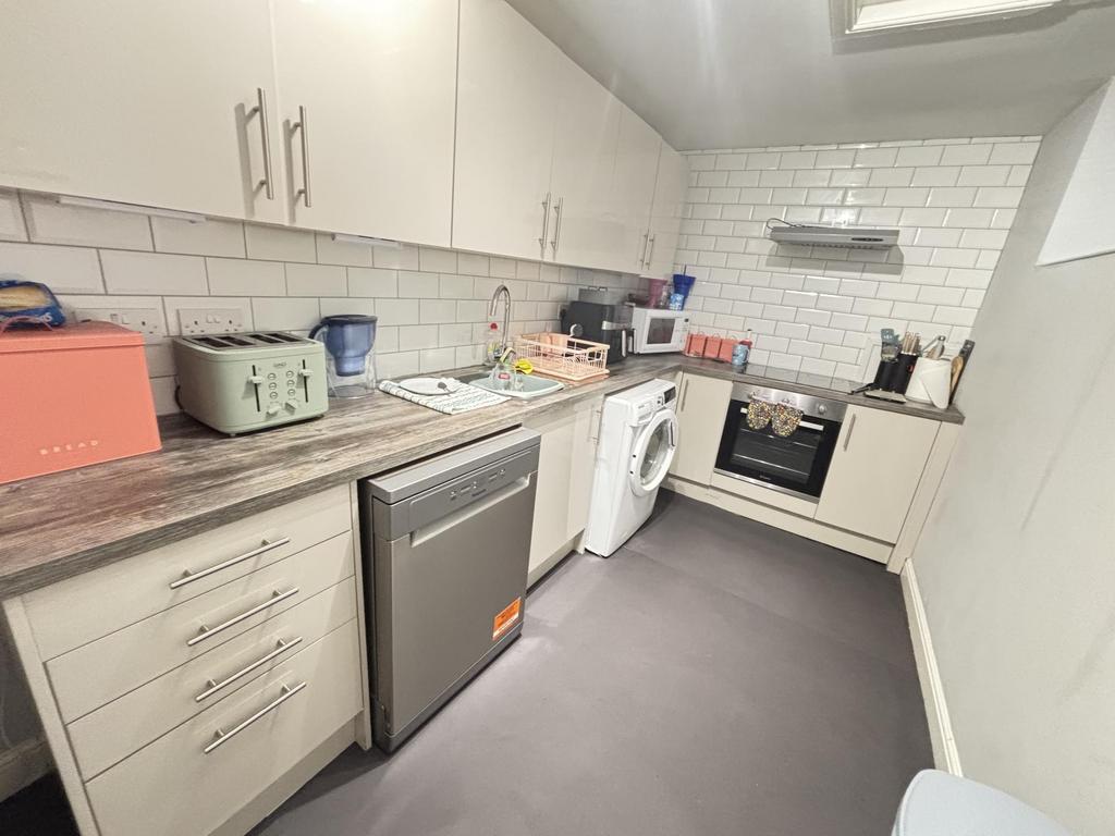 Modern and well-equipped kitchen featuring ampl...