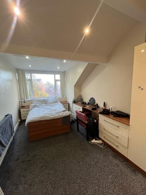 Spacious and well-lit lounge area with a comfor...